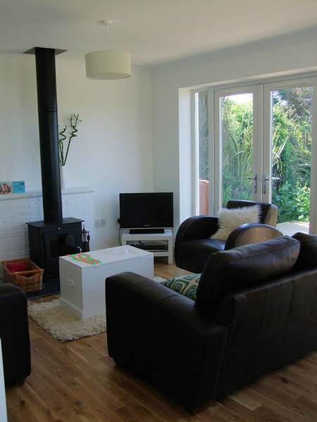 Coast cottage living room - luxury leather sofas and woodburner